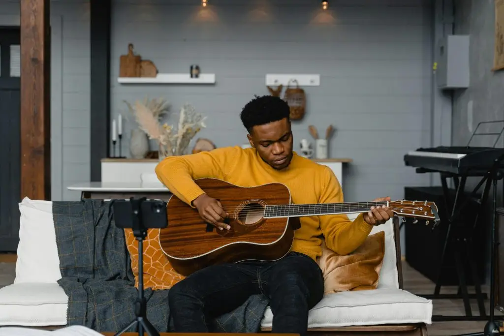 A young man playing the guitar