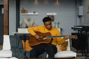 A young man playing the guitar