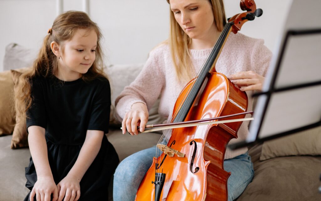 Teaching a student to play the cello during Cello Lessons