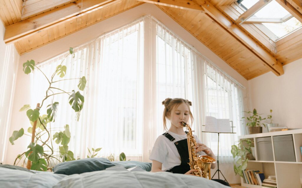 girl playing saxophone at home