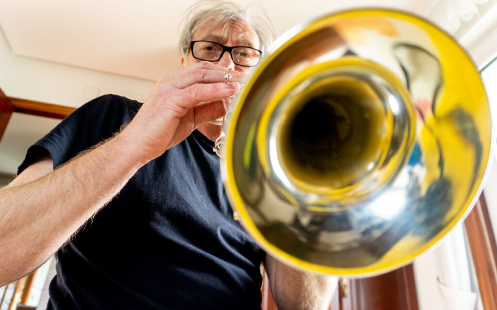 Adult playing trumpet