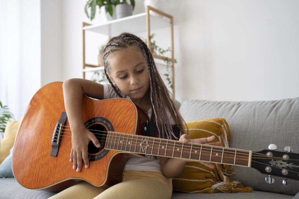 adorable-girl-playing-guitar-home