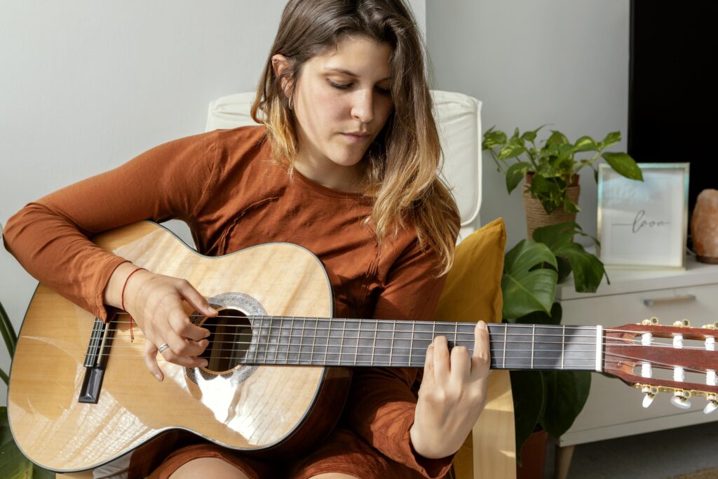 woman-home-playing-guitar